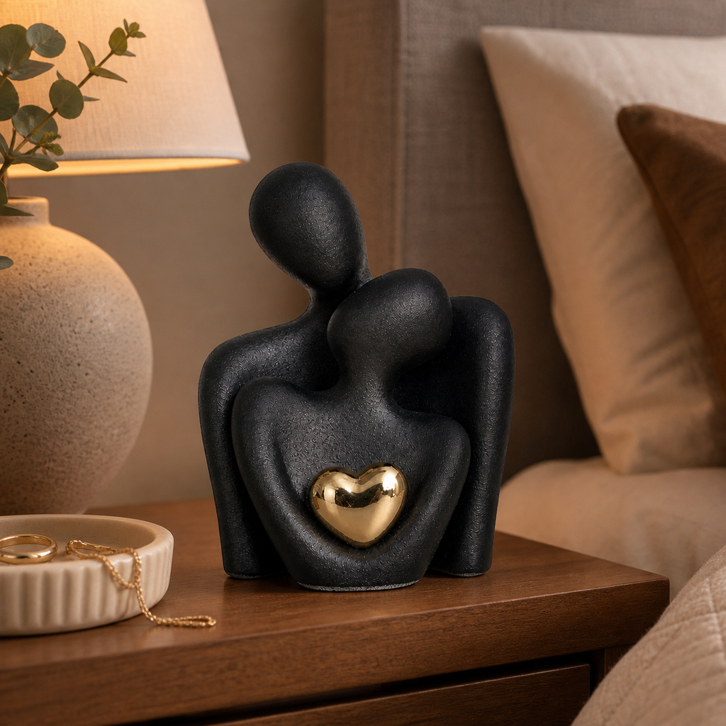 Abstract ceramic couple sculpture with metallic heart detail