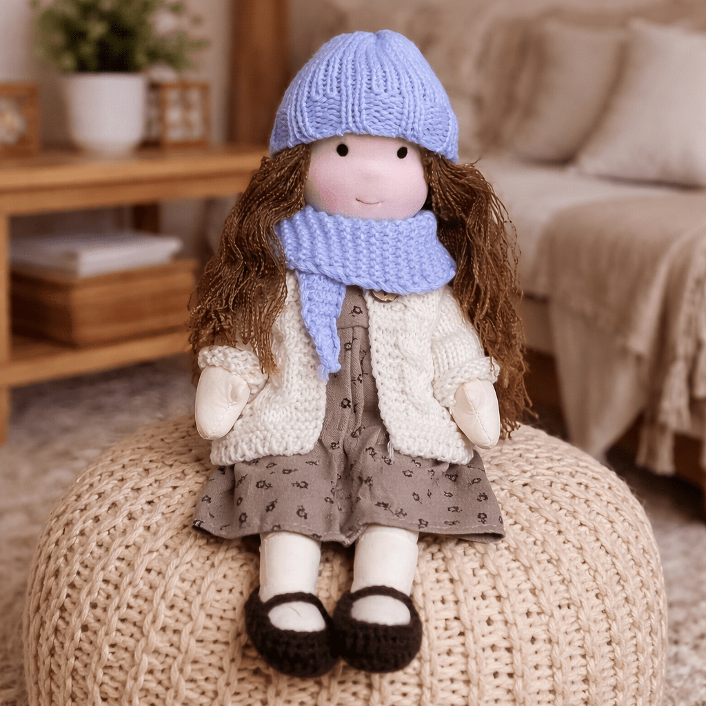Handmade Waldorf doll wearing knitted clothing and a patterned dress
