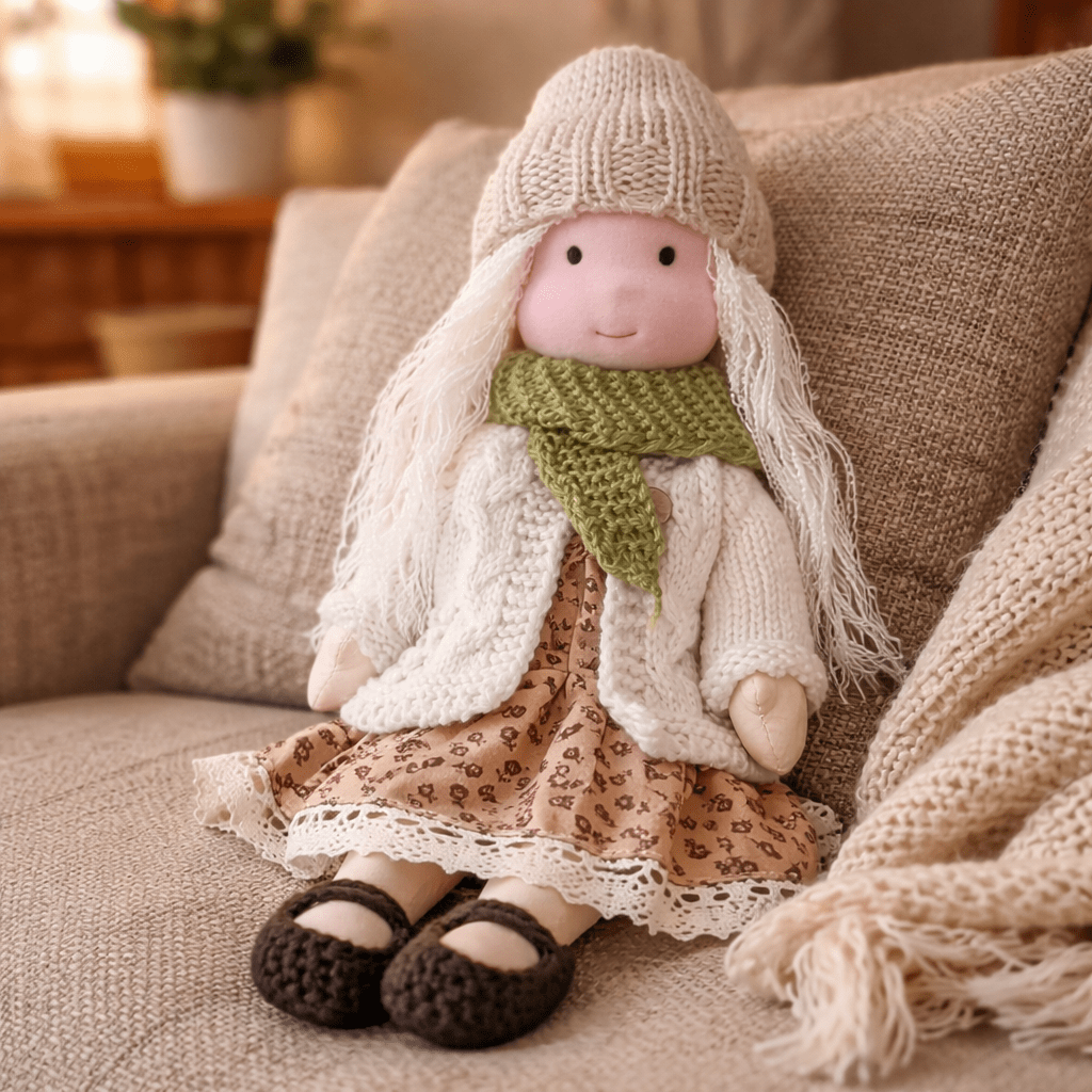 Handmade Waldorf doll wearing knitted clothing and a patterned dress