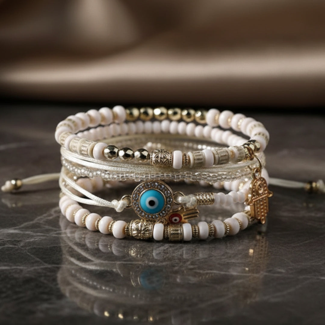 Stacked beaded charm bracelets with eye, hand and heart charms