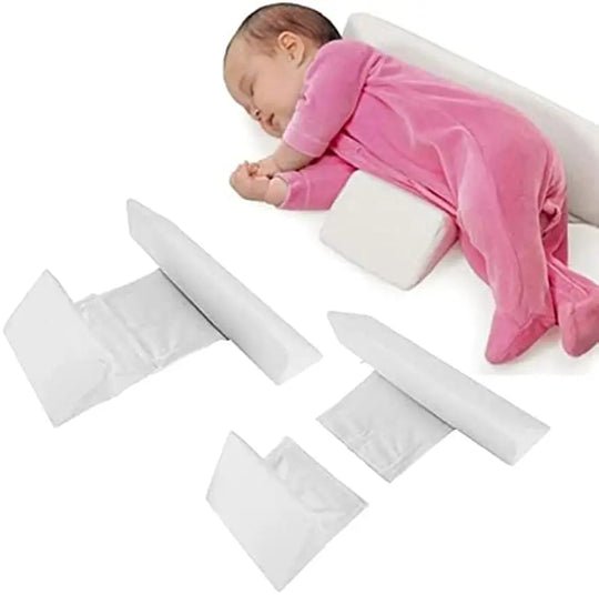 Baby positioning pillow with raised side supports in a cot