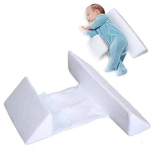 Baby positioning pillow with raised side supports in a cot