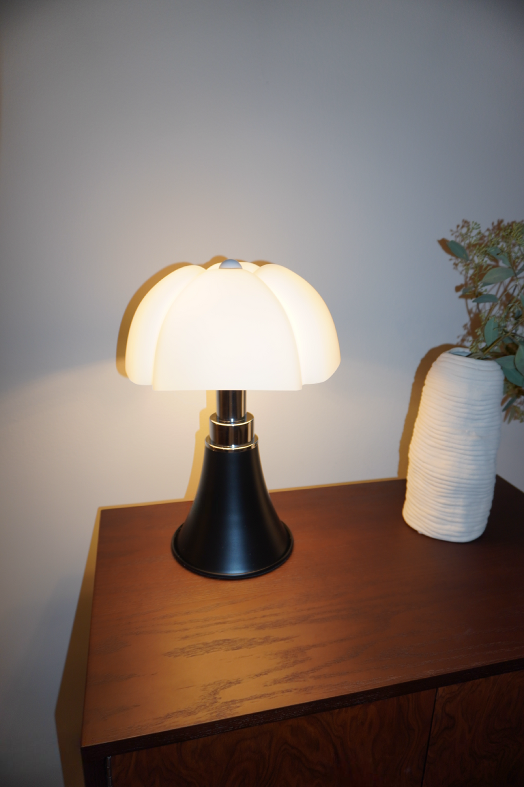 Black table lamp with sculpted soft white petal shade