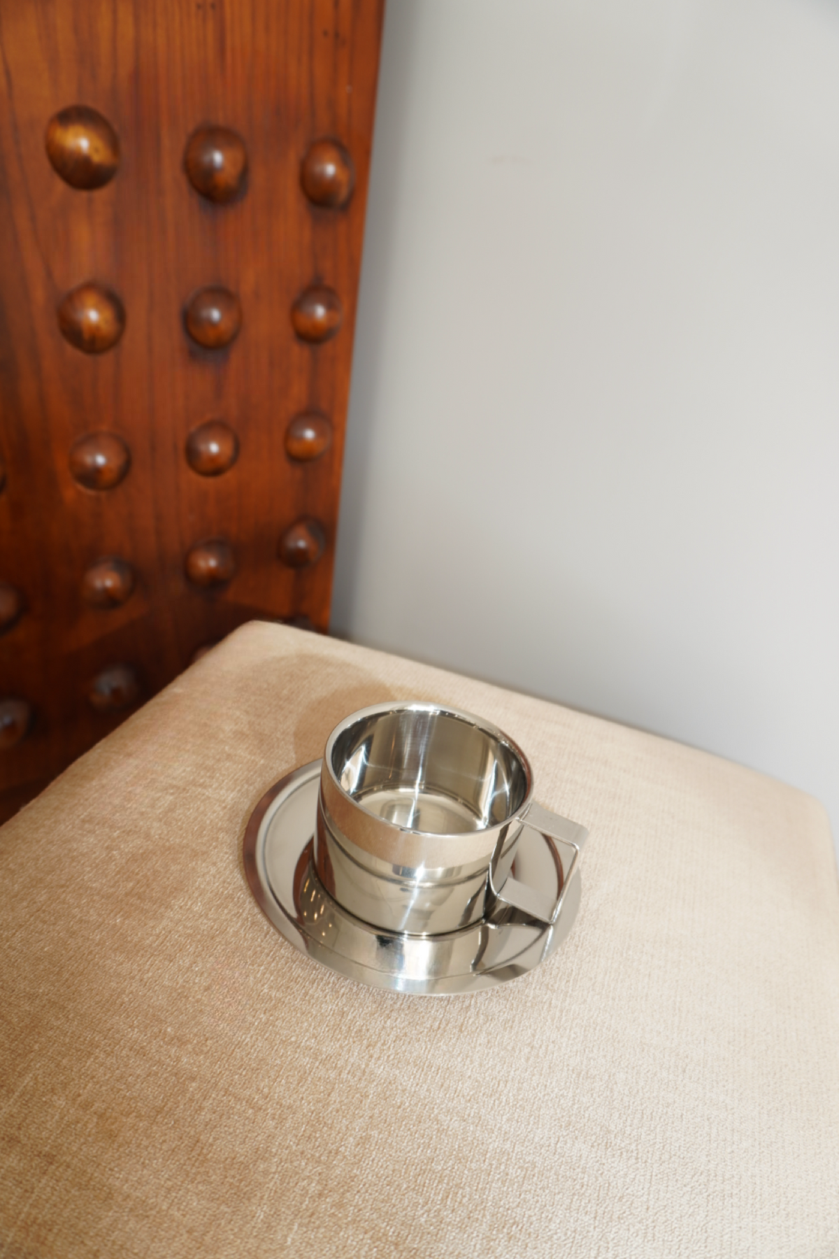 Silver handled coffee mug with matching round saucer