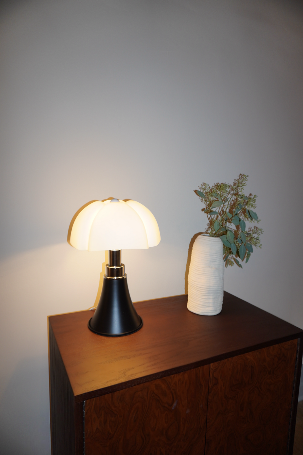 Black table lamp with sculpted soft white petal shade