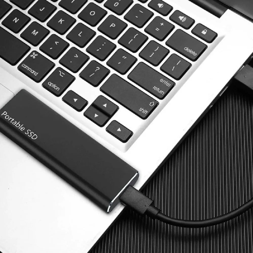 Portable 4TB SSD with USB-C port, cable and connection adapters