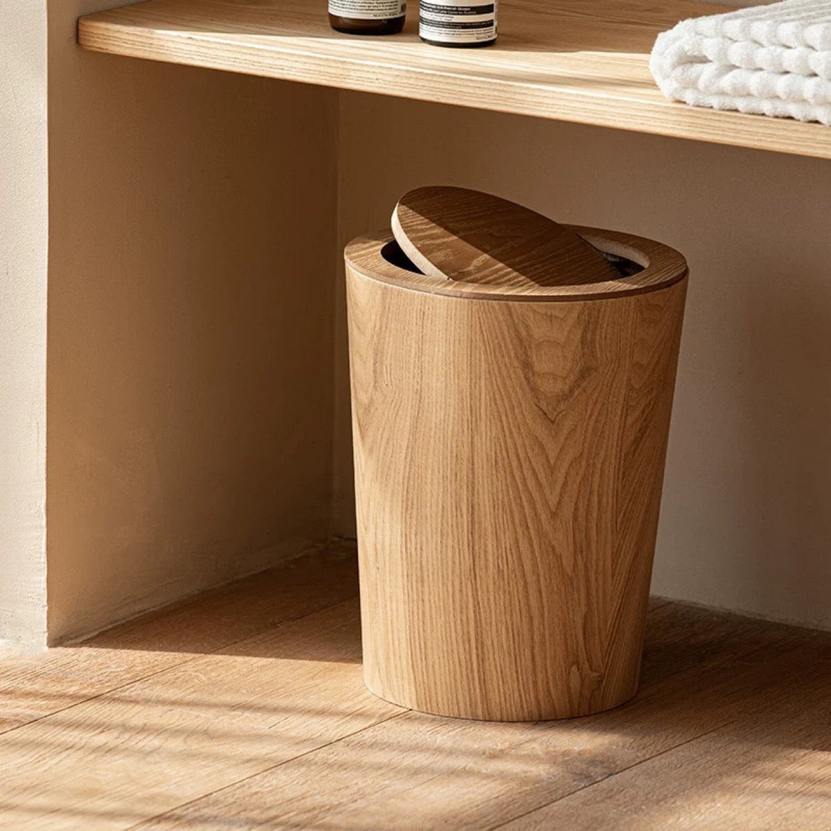 Brown cylindrical wood-effect waste bin with rotating lid