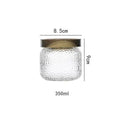 Clear hammered glass storage jar with dark timber lid