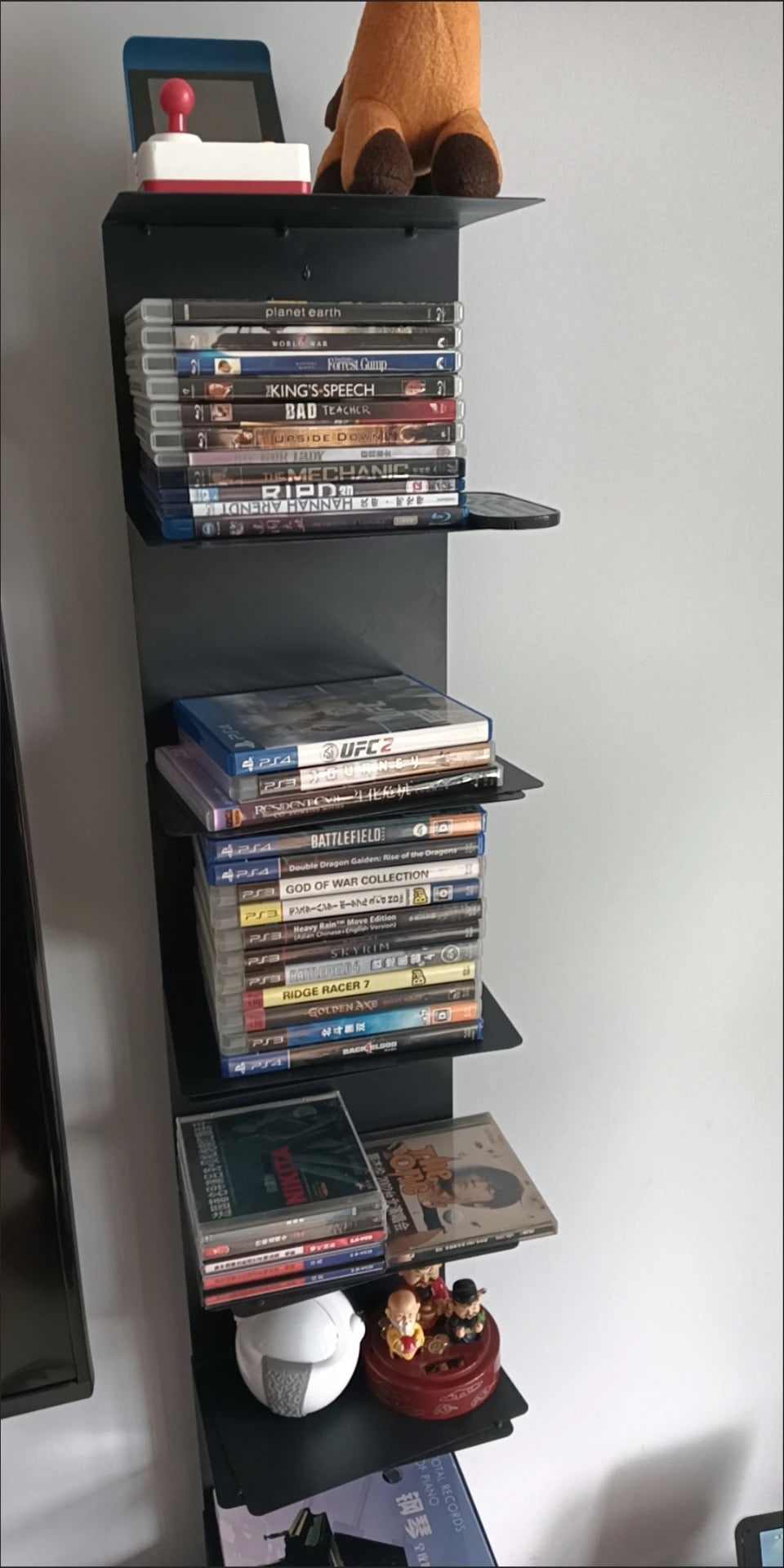 Freestanding tiered metal bookshelf with open shelves and a rectangular base