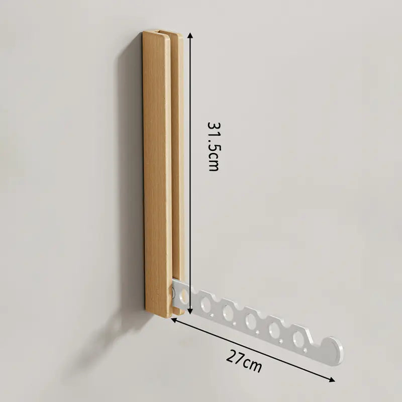 Collapsible wall-mounted hanger rail with wood-effect folding panel and metal hanging bar
