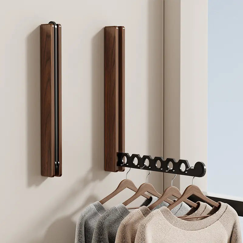 Collapsible wall-mounted hanger rail with wood-effect folding panel and metal hanging bar