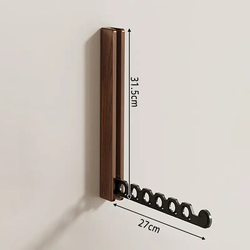 Collapsible wall-mounted hanger rail with wood-effect folding panel and metal hanging bar