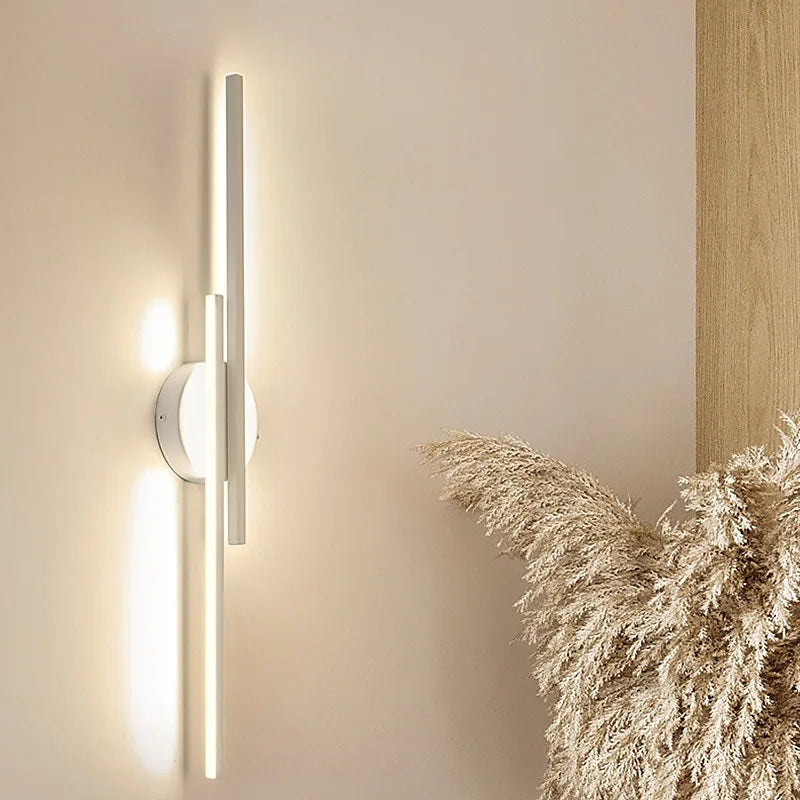 Slim vertical adjustable wall sconce with circular backplate