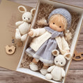 Handmade Waldorf-style doll with knitted rabbit companion and clothing