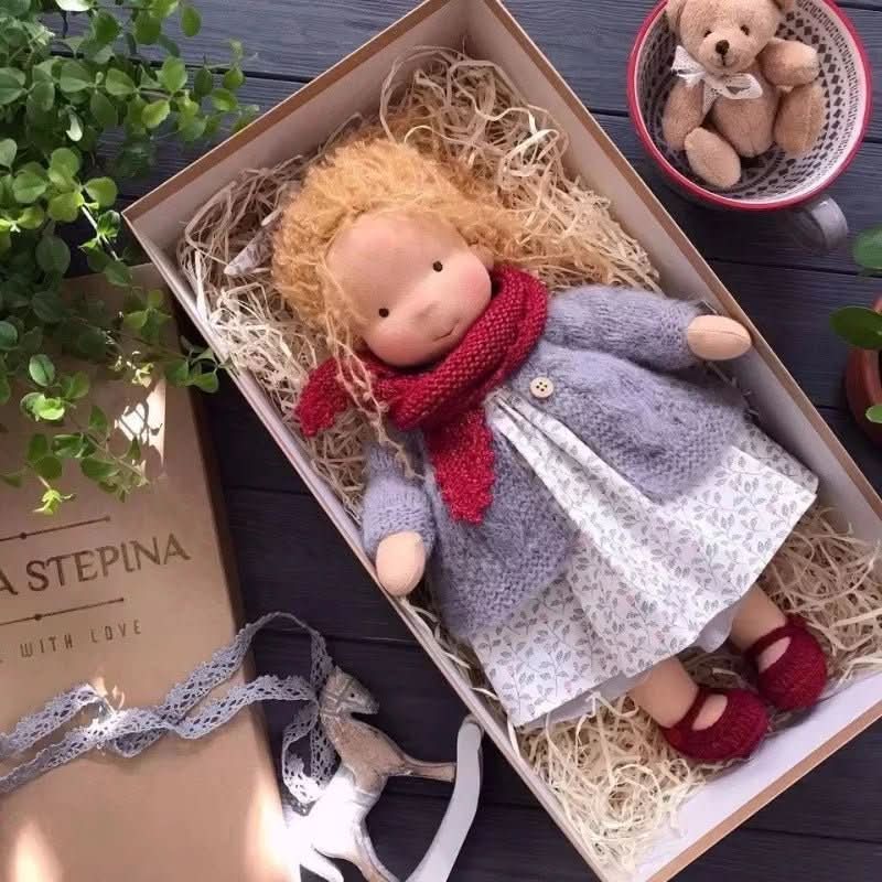 Handmade Waldorf-style doll with knitted rabbit companion and clothing