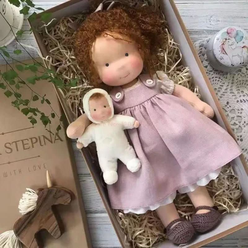 Handmade Waldorf-style doll with knitted rabbit companion and clothing