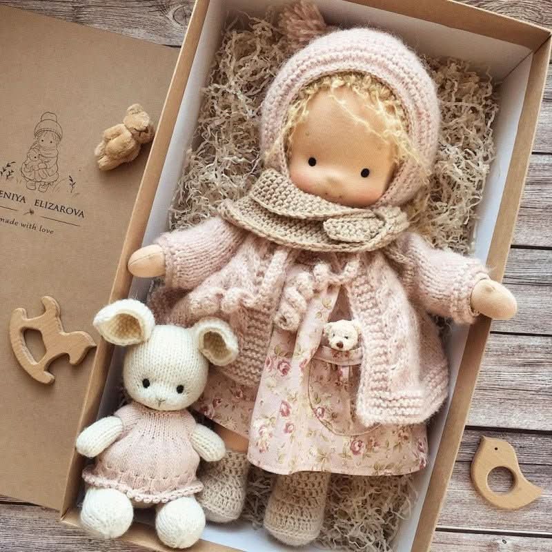 Handmade Waldorf-style doll with knitted rabbit companion and clothing