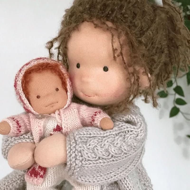 Handmade Waldorf-style doll with knitted rabbit companion and clothing