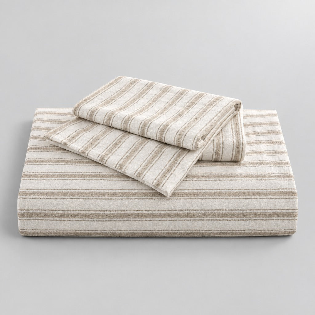 Three-piece striped duvet cover set styled on a bedroom bed