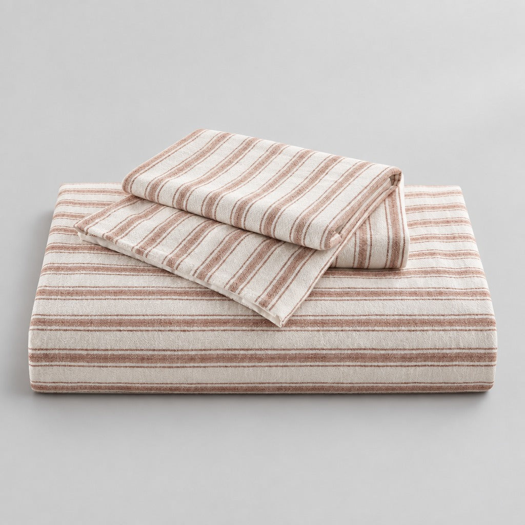 Three-piece striped duvet cover set styled on a bedroom bed