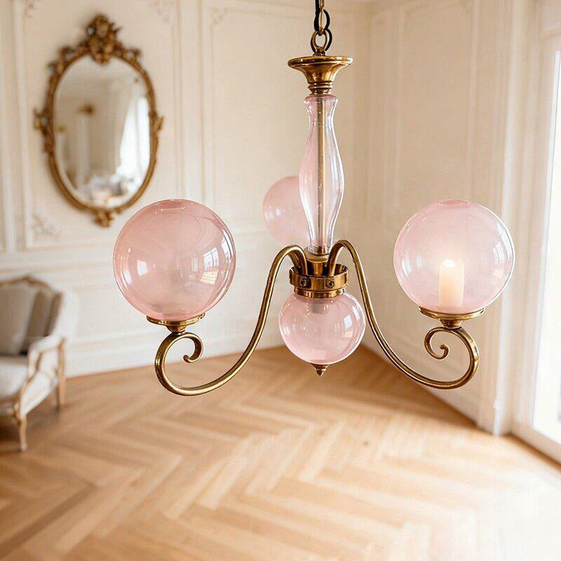 Brass-coloured glass chandelier with pink globes and hanging chain