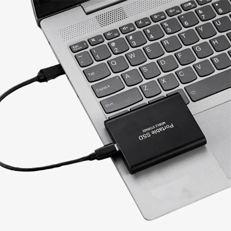 Portable SSD connected to a laptop with a USB cable