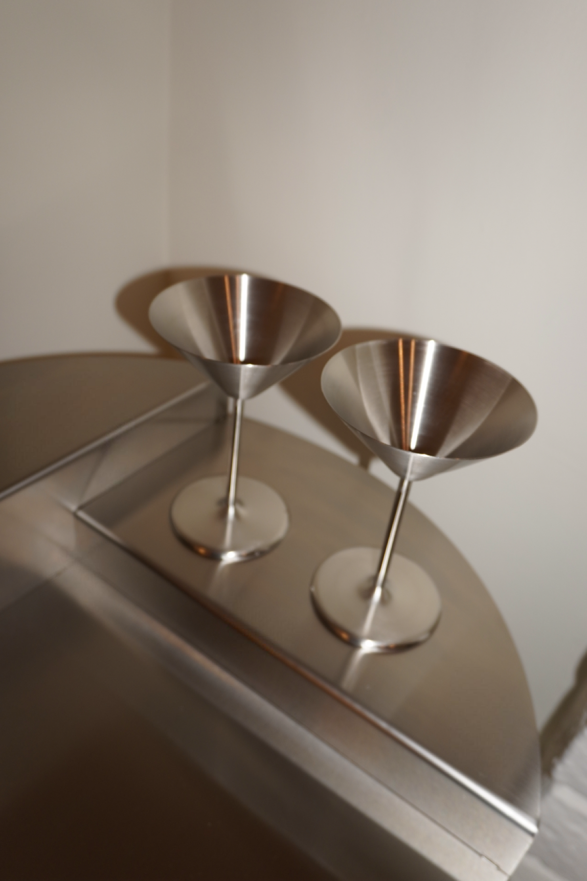 Pair of silver metallic stemmed martini glasses