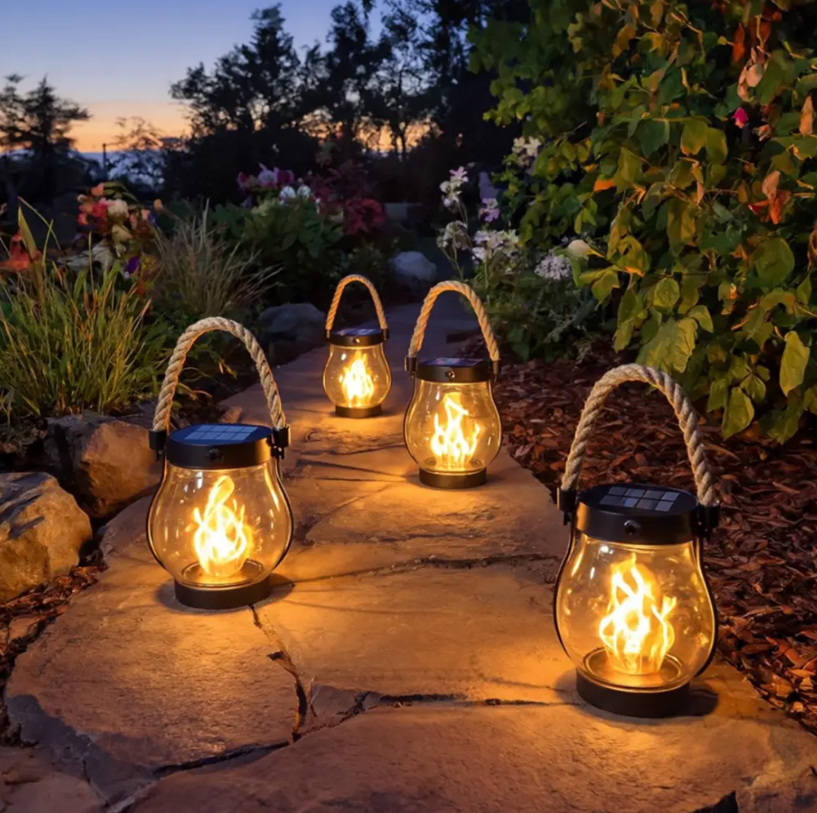 Black solar garden lantern with rope handle and flame-effect light