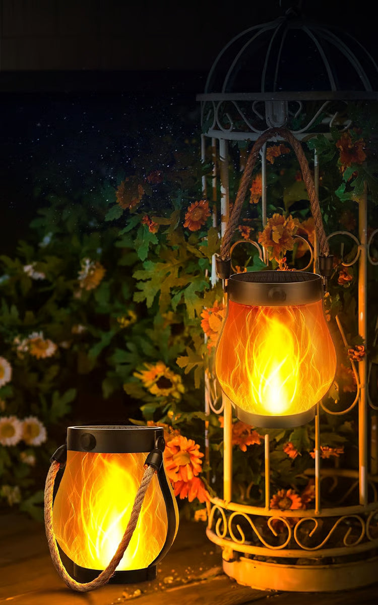 Black solar garden lantern with rope handle and flame-effect light