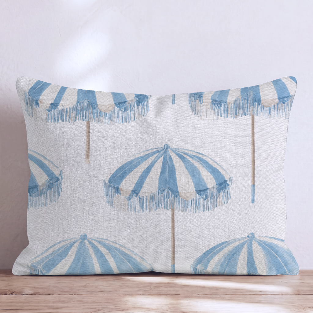 White square throw pillow with a blue umbrella pattern