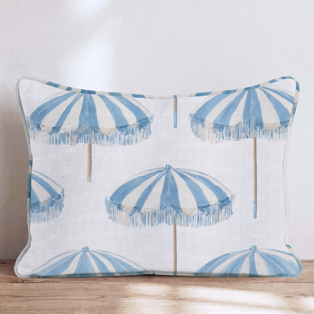 White square throw pillow with a blue umbrella pattern