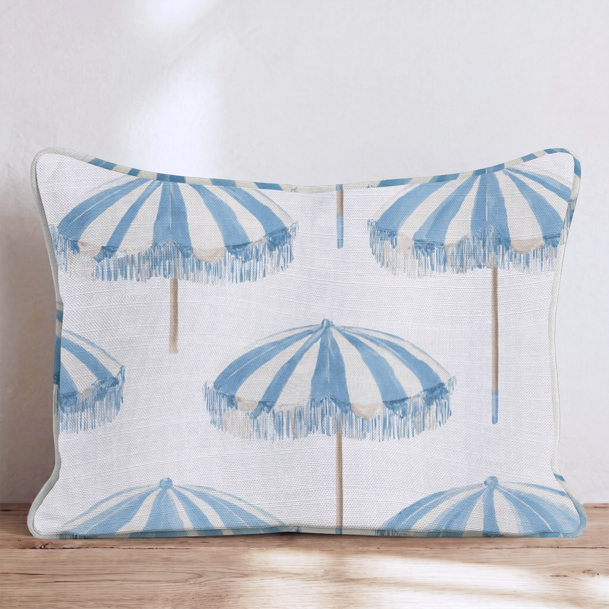 White square throw pillow with a blue umbrella pattern