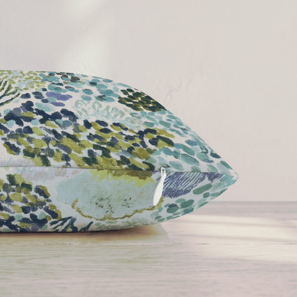 Blue abstract patterned throw pillow with coral-inspired design and piped edges
