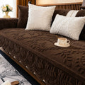 Plush sofa cover with raised botanical leaf texture and scalloped edge