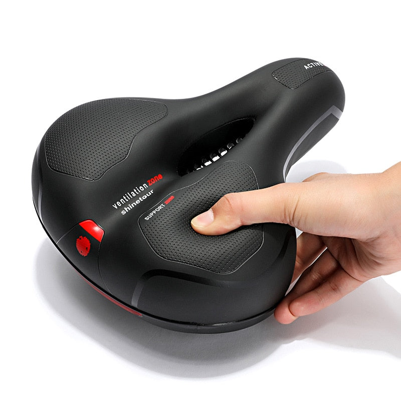 Ergonomic bicycle saddle with ventilated centre and textured comfort panels