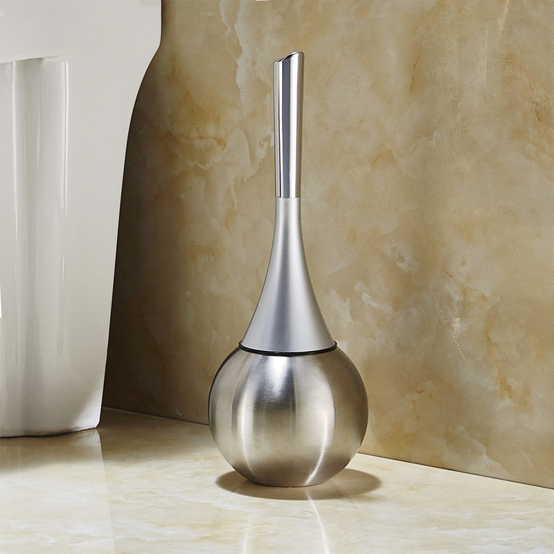 Freestanding toilet brush and rounded holder in metallic finish