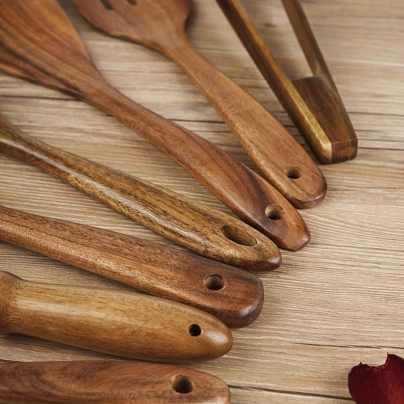 Seven-piece brown wooden kitchen utensil set with spoons, spatulas, tongs and whisk