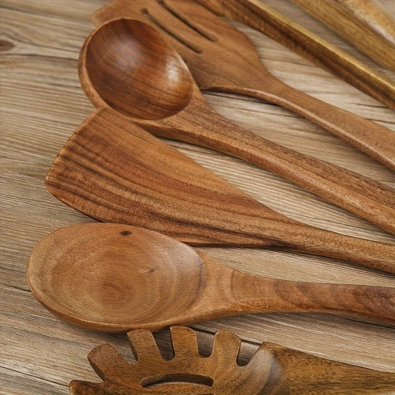 Seven-piece brown wooden kitchen utensil set with spoons, spatulas, tongs and whisk