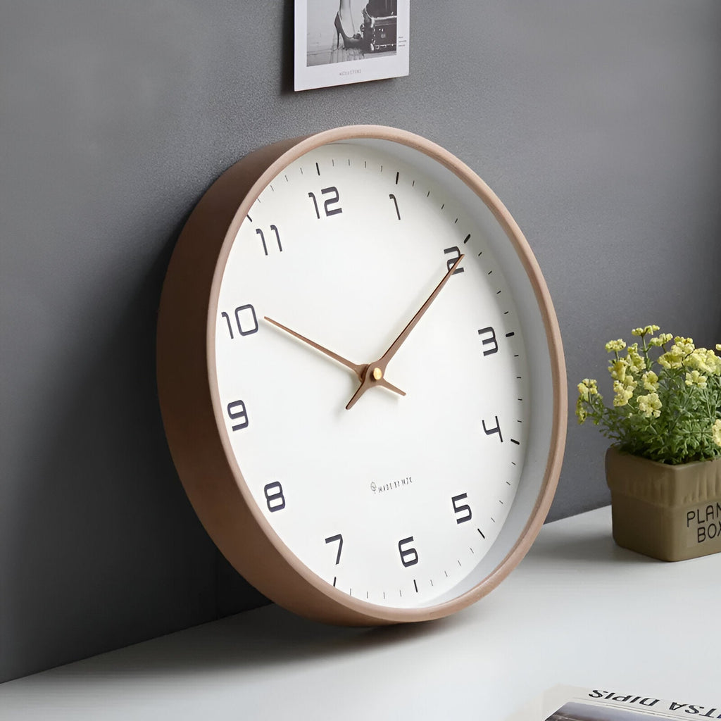 Round analogue wall clock with bold numerals and wood-effect frame
