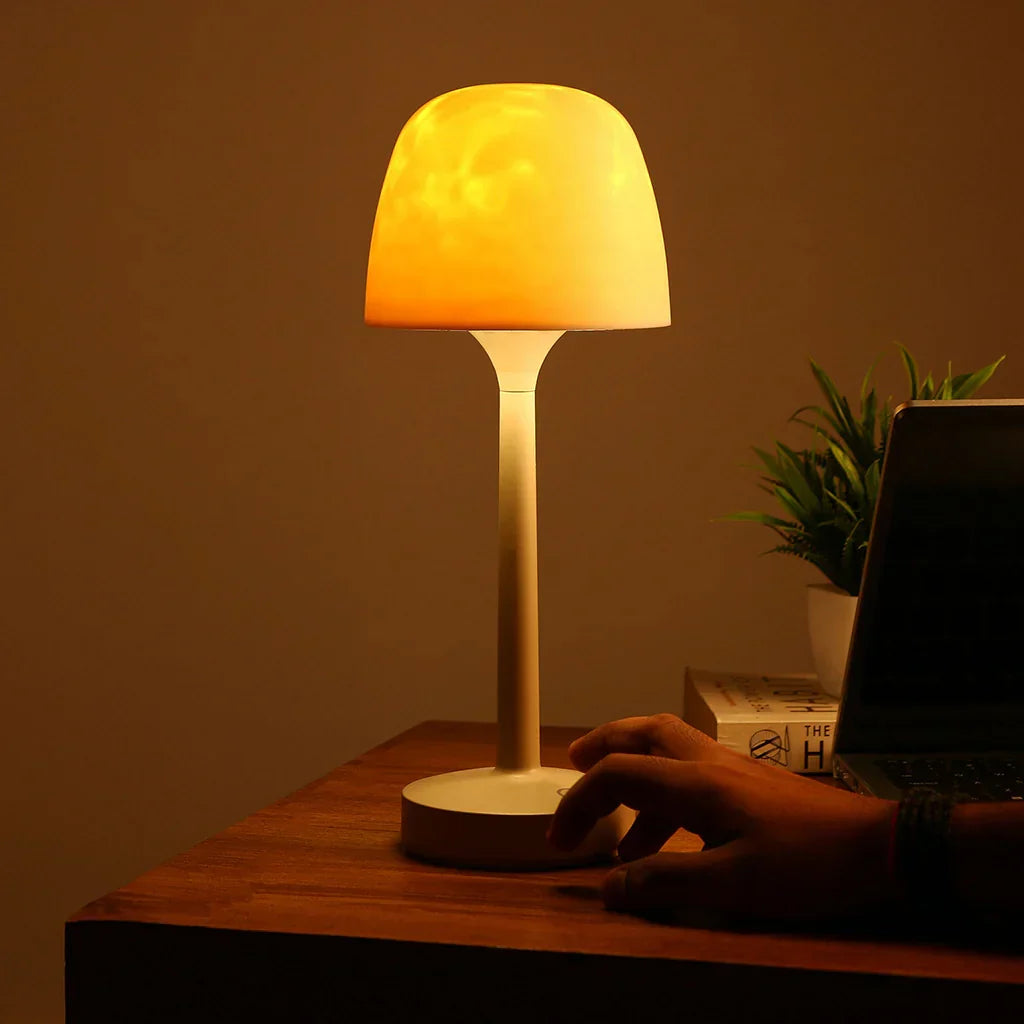 Cream wireless table lamp casting warm aurora-style light patterns