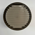 Round wall sconce with ribbed circular shade and dark outer rim