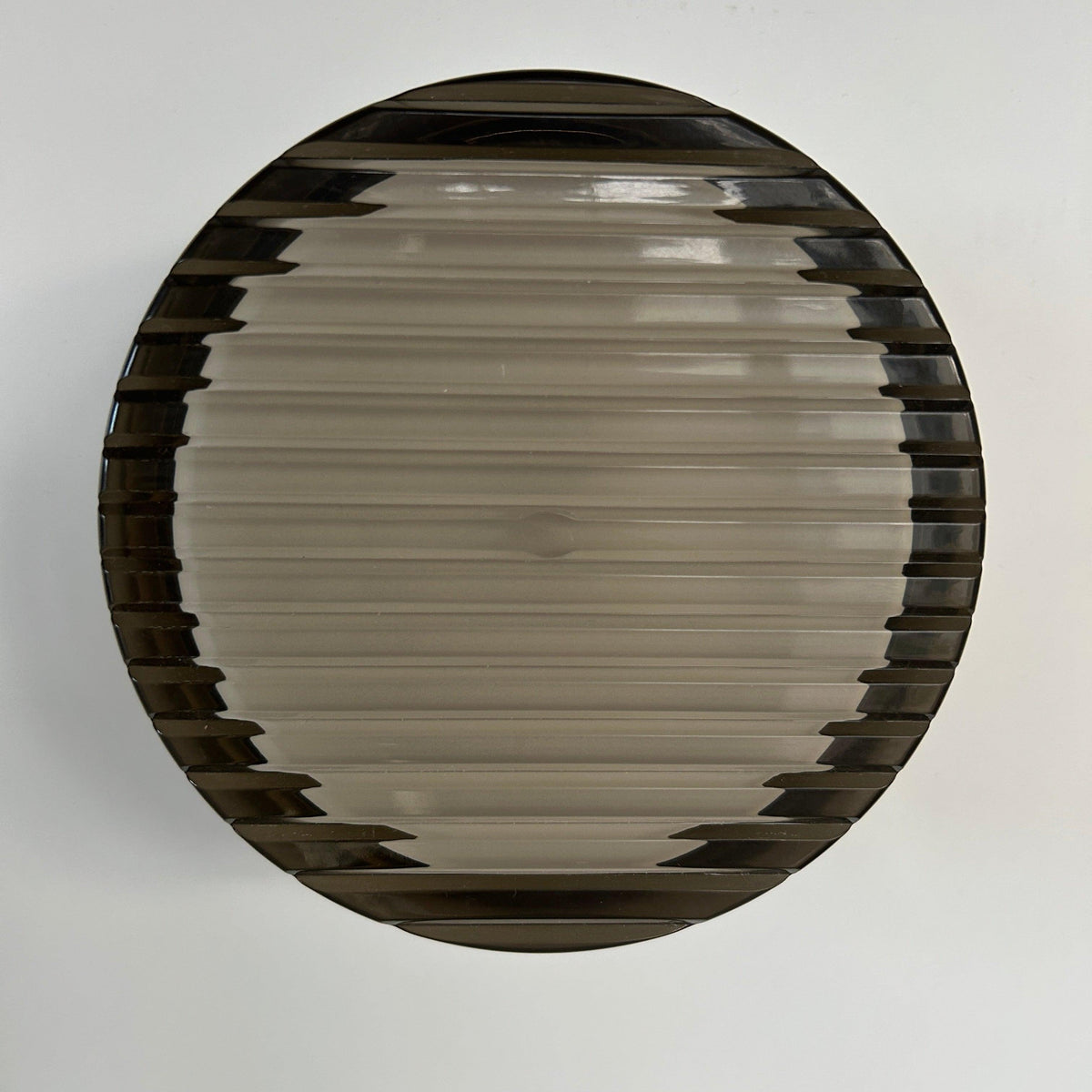 Round wall sconce with ribbed circular shade and dark outer rim
