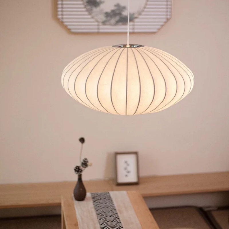 White oval ribbed pendant ceiling light suspended by a white cord