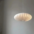 White oval ribbed pendant ceiling light suspended by a white cord