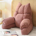 Cushioned bed reading pillow with raised arm supports and ribbed cover