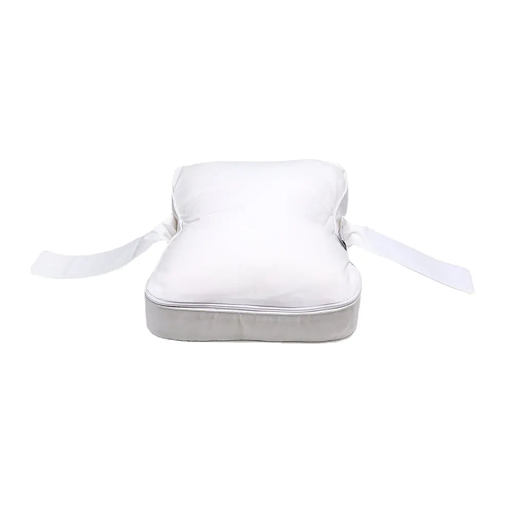 Contoured memory foam knee pillow with attached leg strap between the legs