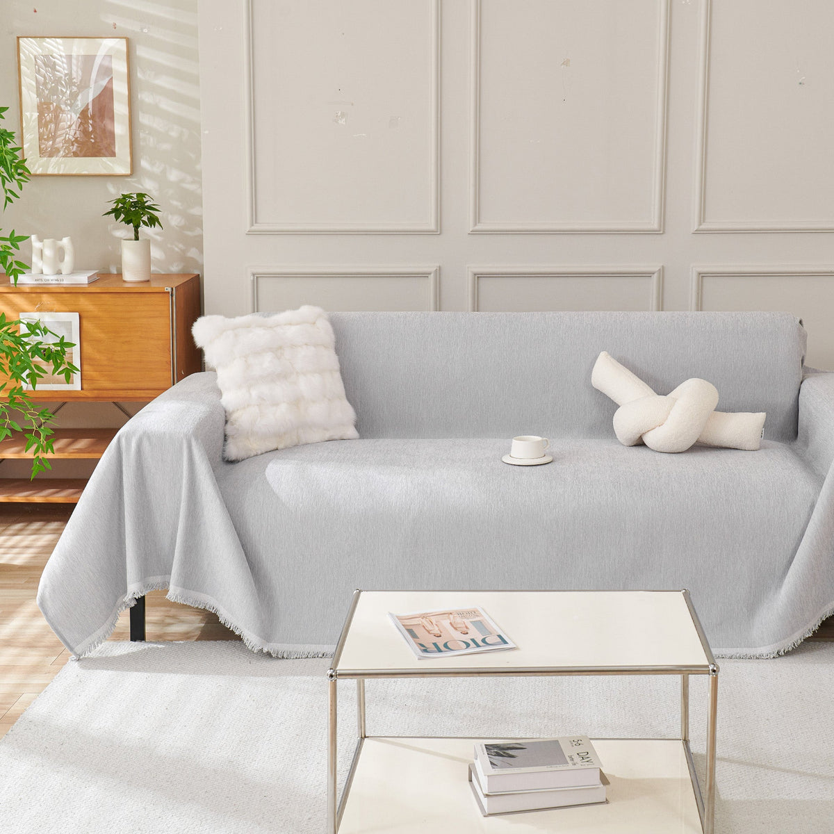 Draped fringed sofa cover on a living room sofa