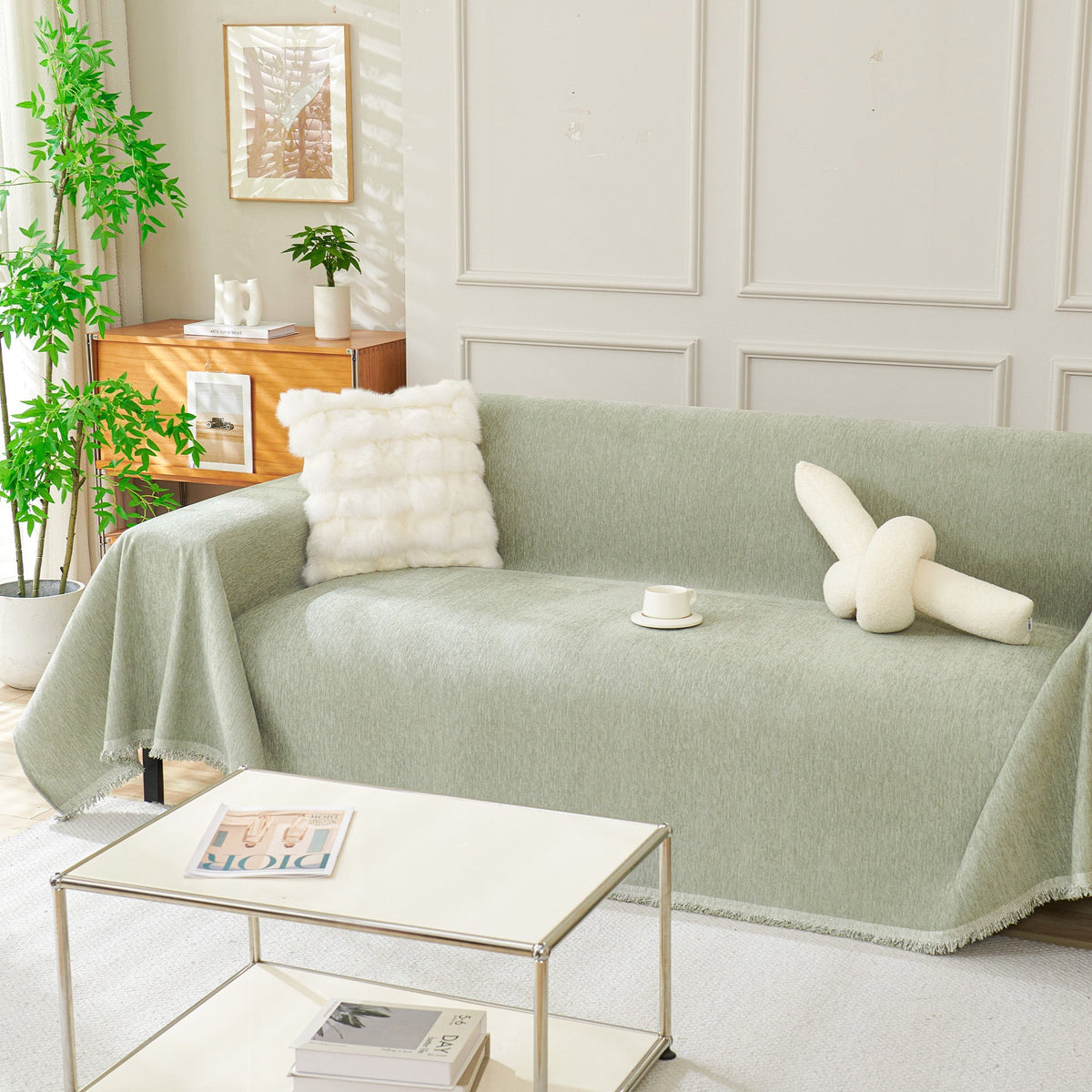 Draped fringed sofa cover on a living room sofa