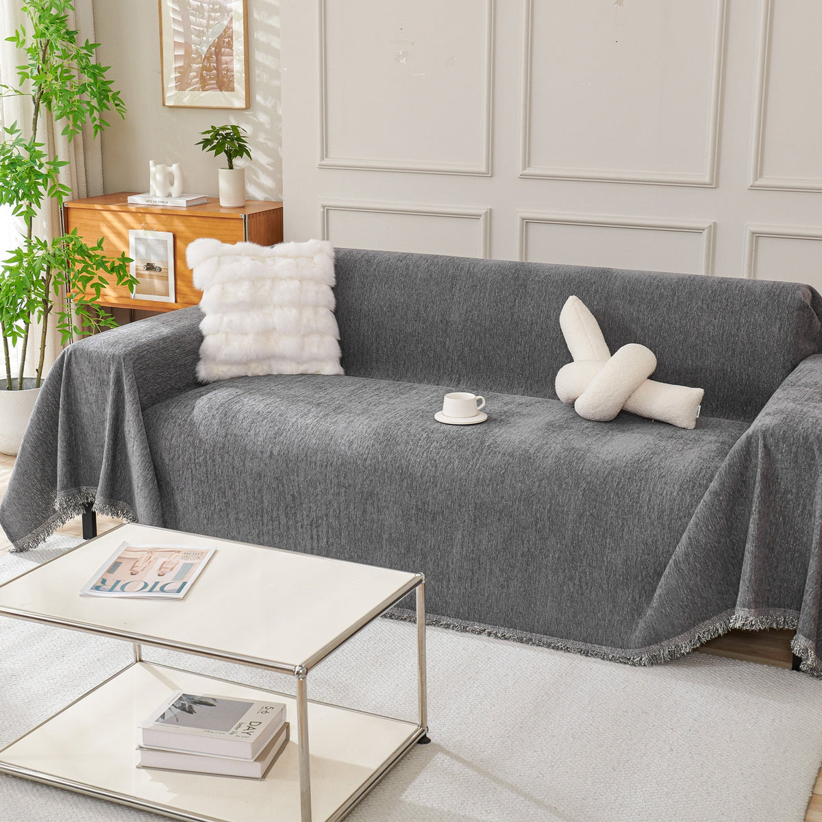 Draped fringed sofa cover on a living room sofa