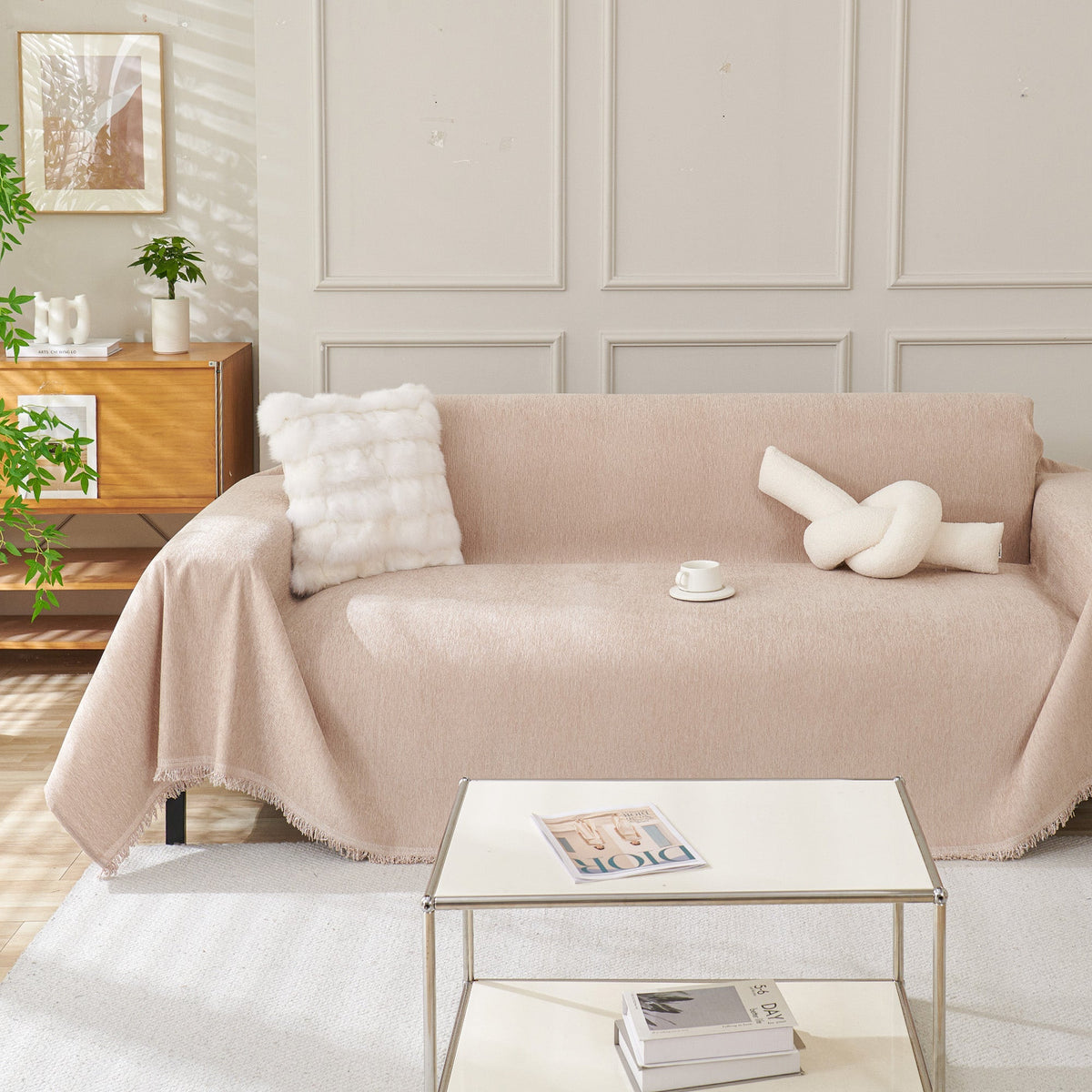 Draped fringed sofa cover on a living room sofa